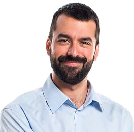 Man with short dark hair and beard wearing a light blue button-up shirt