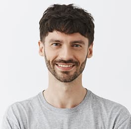 Person in a light gray t-shirt against a plain white background