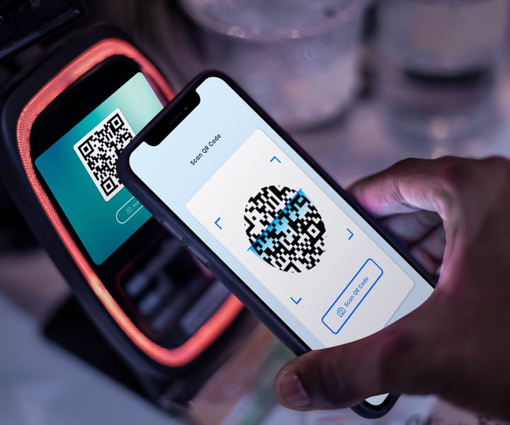 a terminal shows a QR payment link and a phone scans it